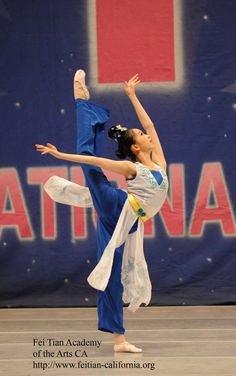 a woman is doing an acrobatic dance