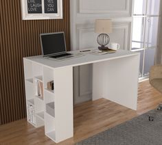 a laptop computer sitting on top of a white desk next to a lamp and chair