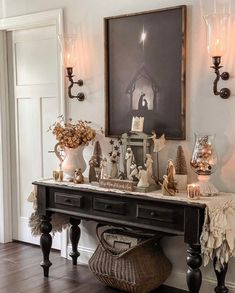 a console table with candles and decorations on it