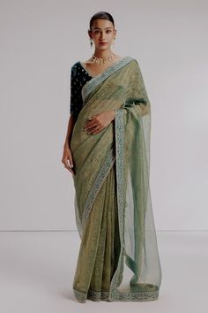 Green saree featuring sequin embroidered floral border on an textured base. Comes with velvet silk thread embroidered blouse and petticoat. - Aza Fashions Party Pre-draped Saree With Zari Work In Slub Silk, Cotton Silk Pre-draped Saree With Dupatta For Reception, V-neck Saree For Reception And Festivals, Festive V-neck Saree With Dupatta, Festive Cotton Silk Pre-draped Saree With Sheer Dupatta, Georgette V-neck Blouse With Zari Work, Bollywood Style Slub Silk Blouse With Sheer Dupatta, Navratri Tissue Silk Pre-draped Saree With Chikankari Embroidery, Anarkali Cotton Silk Pre-draped Saree For Reception