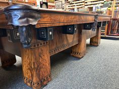 an antique pool table in the shape of a bull's head is on display