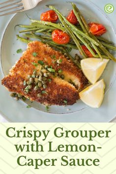 crispy grouper with lemon - caper sauce on a white plate next to green beans and tomatoes