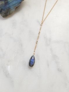 Beautiful Labradorite Waterfall Necklace. Always a gorgeous and magical gemstone! Wear this with a V neck or over a t-shirt for a more casual look. The length of the drop from the little center circle down to the bottom of the stone is just over 2 1/2 in. The chain on the drop is a beautiful bar chain. Each Labradorite is unique and will slightly vary as they are natural. Some will have more of a blue color and others may be more green, yellowish-green, purple-blue, and silverish. If you have a Elegant Labradorite Necklace With Adjustable Chain, Drop Necklace With Stones As Gift, Drop Necklace With Stones For Gift, Gift Drop Necklace With Stones, Elegant Labradorite Teardrop Pendant Jewelry, Bohemian Teardrop Necklace With Adjustable Chain, Teardrop Gemstone Necklaces For Healing, Adjustable Teardrop Stone Necklace, Dainty Gemstone Drop Necklace