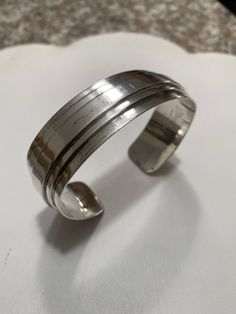 "Offered for your consideration : Vintage Yale Sterling Silver modernist mid century cuff bracelet, circa 1960's. This beauty is in in very good condition, light surface wear from use, free from damage. It measures approximately 2.75\" across, approximately 7\" inner circumference & .75\" wide.... It weighs a hefty 2.5 oz./ 70.87 grams. Signed Sterling by Yale inside the cuff. Gorgeous & it would make a lovely Gift idea! Securely packaged for Free Priority shipping If you get a chance to Classic Metal Cuff Bracelet With Polished Finish, Vintage Bangle Bracelet With Polished Finish, Vintage Bangle Bracelets With Polished Finish, Classic Metal Cuff Bangle, Modern Polished Cuff Bangle, Modern Cuff Bangle With Polished Finish, Modern Metal Bangle With Polished Finish, Modern Wide Band Bangle With Polished Finish, Vintage Cuff Bangle With Polished Finish