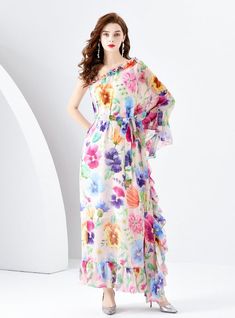 Overflowing with vibrant colors and whimsical charm, this one-shoulder maxi dress is a walking canvas of floral exuberance. It’s a garment that embodies the joy and freedom of spring, with its flowy fabric cascading gracefully to create a dreamlike silhouette. The dress’s design features a stunning spectrum of blooming flowers, each petal painted with the promise of new beginnings. An asymmetrical neckline bares the shoulder in a tasteful display of elegance, while the ruffled overlay adds a playful touch of femininity. Perfect for outdoor weddings or garden parties, this dress ensures you’ll float through events with the effortless grace of a petal on the breeze. It is a celebration of style, comfort, and the natural beauty that inspires it all, making it a must-have for the season. Fabri Garden Of Flowers, Flowy Fabric, Outdoor Weddings, Asymmetrical Neckline, Garden Parties, S Design, The Promise, Blooming Flowers, Printed Dress