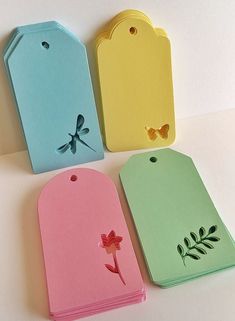 four different colored tags with designs on them