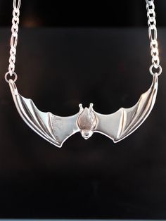 "This striking Bat Pendant is cast in solid sterling silver. It is sculpted both front and back with a wing span is 2 1/4\". A 16\" figaro chain is attached to both wing tips and is included in the price of this piece making the total length of the pendant just over 18\". All Marty Magic Jewelry is packaged in a beautiful box, embossed with the gold foil Marty Magic dragon logo. Perfect for any occasion! Designed in California by Marty Magic. Made in the U.S.A." Bat Clothes, Magic Jewelry, Bat Pendant, Dragon Logo, Magic Dragon, Bat Jewelry, Bat Necklace, Jewelry Halloween, Bat Earrings