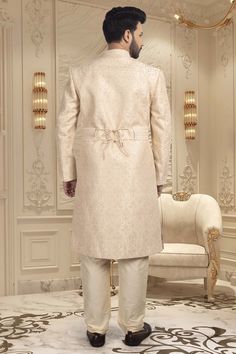 Make your big day even more special with our Mens Sherwani S20-S368! This groom's sherwani is adorned with stunning stones, adding a touch of luxury to your wedding ensemble. It will make you shine on your big day. Luxury Bandhgala For Groom, Wedding Suits With Dabka And Traditional Drape, Traditional Drape Wedding Suits With Dabka, Dabka Embellished Wedding Suits With Traditional Drape, Designer Cream Kurta For Wedding, Elegant Sherwani For Reception With Traditional Drape, Luxury Wedding Sherwani With Intricate Embroidery, Designer Cream Traditional Wedding Wear, Luxury Cream Wedding Sets