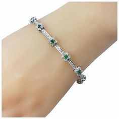 This stunning bracelet features 13 round emeralds (2 mm each) and 112 round brilliant cut diamonds set in classic 18K white gold.    Width:  5 mm  Total diamond weight:  1.10 ct.  Diamond color: H-J  Diamond clarity: SI1  Size: 6.75 inches  Weight:  7.9 dwt. /  12.4 gr.  Stamped: 18K  BA  Very good condition, professionally polished.  Will come packaged in a gift box or pouch (when possible) and will be shipped U.S. Priority Mail Insured. Elegant Silver Tennis Bracelet With Emeralds, Elegant Silver Emerald Tennis Bracelet, Luxury Silver Tennis Bracelet With Emeralds, Silver Emerald Tennis Bracelet For Formal Occasions, Formal Silver Tennis Bracelet With Emeralds, Formal Silver Emerald Tennis Bracelet, Classic Green Diamond Bracelet With Brilliant Cut, Elegant White Gold Tennis Bracelet With Emeralds, Green Brilliant Cut Diamond Bracelet For Anniversary