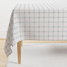 a white and blue checkered tablecloth with wooden legs