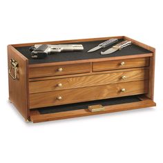 a wooden chest with drawers and tools on top