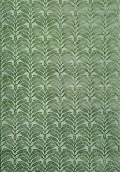 a green rug with leaves on it