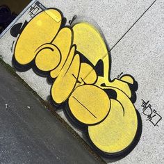 graffiti on the side of a building with yellow and black letters that spell out love