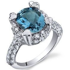 a blue topazte and diamond ring on a white background