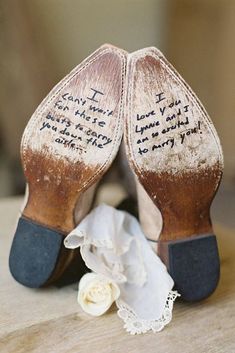 wedding shoes with writing on them sitting on a table