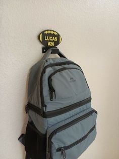 a gray backpack hanging on the wall