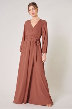 Warm and inviting, the Wholehearted Maxi Dress is a perfect combination of modest and sultry. Long balloon sleeves frame a surplice neckline separated by a tie at the waist, creating a forgiving faux wrap. The skirt maintains an airy and flowy shape that trails behind as you walk down the aisle. - Chiffon- Faux wrap- Keyhole- Elastic waist- Comes in 14 ColorsSize + Fit - Model is 5'9" and wearing size XS- Measurements taken from size S - Chest: 35"- Length: 63 1/4" Fabric Self: 100% PolyesterLin Shoulder Ruffle Dress, Long Sleeve Wrap Dress, Wrap Maxi Dress, Surplice Neckline, Rust Dress, Backless Maxi Dresses, Sleeve Maxi Dress, Long Sleeve Maxi, Maxi Wrap Dress