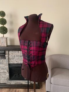 This is the perfect bodice to add to your wardrobe for this years Renaissance and cosplay events! The bodice is a soft, woven wool plaid, in the wine, hunter green, and black Lindsay tartan. The bodice is fully lined, and interlined with 2 layers of canvas, and double-boned at the center fronts. This bodice features a standing collar and the bodice hits mid-bust. The bodices laces closed through 14 black grommets. The bodice measures 36 inches at the bust and 32 inches at the waist, your bust sh Lindsay Tartan, Irish Celtic, Tartan Dress, Standing Collar, Mini Dresses For Women, Women's Costumes, Costume Dress, Wool Plaid, Tartan Plaid