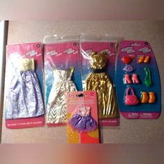 three barbie dolls in plastic packaging on a counter top, one is wearing a dress and the other has shoes