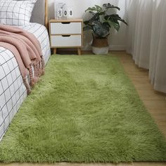 a bedroom with a green rug on the floor