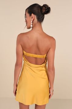 the back of a woman wearing a yellow dress