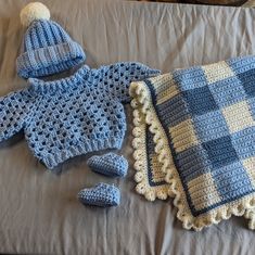 a crocheted blanket, hat and booties are laying on a bed