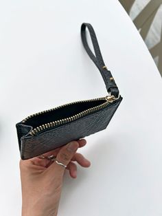 This slim and lightweight cardcase is an every day essential to throw in any bag or in your pocket. It features a 7” wristlet pull with metal pegs that open to accommodate your keys. The exterior has four dedicated card slots and the main zippered compartment holds additional cards and/or cash. Redefine your everyday carry with a touch of luxury and practical elegance. PLAY CARDCASE FEATURES Sustainable Up-cycled embossed leather 100% cotton twill lining 7" Wristlet pull with key slot 4 Exterior Trendy Card Holder With Zipper For Everyday Use, Trendy Card Holder With Zipper Closure For Everyday Use, Travel Card Holder With Zipper Closure, Travel Rectangular Card Holder With Zipper Closure, Versatile Card Holder With Zipper Closure, Daily Use Pouch Card Holder With Zipper, Modern Travel Card Holder With Zipper Closure, Versatile Coin Purse With Card Slots For On-the-go, Rectangular Card Holder With Zipper Closure For Everyday