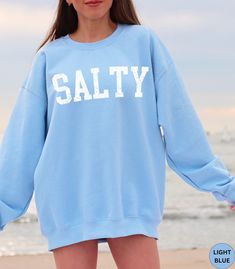 🏝️Discover our Salty Beach Vibes Summer Beach Vacation crewneck Sweatshirt!🏝️ This Trendy beachy sweater features an eye-catching white distressed graphic design. It is super soft and comfortable and designed to enhance your beach vibes. It will have you dreaming of your next beach vacation! Perfect as an oversized beach cover up or wear it with jeans or shorts for a super cute look on a casual day out. Makes a nice gift for a Birthday or for a Beach lover! Comes in 14 pretty colors. ✨PRINT: T