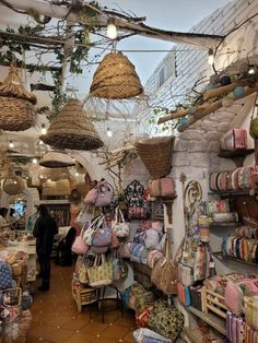 the inside of a store with baskets and bags hanging from it's ceilings