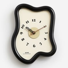 a black and white clock with numbers on it's face is shown in front of a white background