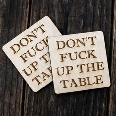 two coasters that say don't touch, put it up and the table