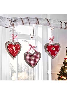 three heart shaped ornaments hanging from a branch