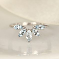 a white gold ring with three pear shaped diamonds