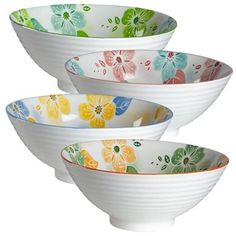 three white bowls with colorful flowers on them