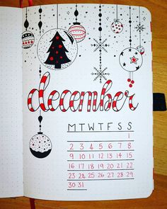 a calendar with christmas ornaments hanging from it's sides and the word december written in red ink