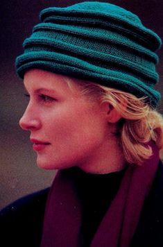 a woman with blonde hair wearing a green hat