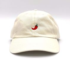 Description: Add a dash of flavour to your wardrobe with our Embroidered Mini Chilli Cap! This cap is perfect for those who appreciate the heat and want to showcase their fiery personality. The front of the cap features a charming mini chilli embroidered design that will surely make a statement wherever you go. Choose from a variety of cap colours, including beige, mint green, pale blue, navy, pink, lemon, and black, to suit your individual taste. Personalisation: Make this cap truly one-of-a-kind by opting for a personalised touch. With our back embroidery option, you can add your name or initials to the cap's back. When placing your order, simply let us know your desired text in the personalisation box. To further customise your back embroidery, select your preferred font style and threa Casual Embroidered Fitted Hat With Flat Bill, Casual Embroidered Dad Hat With Flat Bill, Embroidered Cotton Dad Hat With Flat Brim, Casual Embroidered Dad Hat With Flat Brim, Hand Embroidered Hat, Embroidered Hats Baseball Caps, Cap Aesthetic, Fiery Personality, Baseball Cap Design