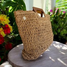 This lightweight natural straw handbag is expertly hand-woven and includes a wooden handle, inner pocket and zip closure. Measuring approximately 13" tall and 16" high, this bag also features a fabric lining on the inside. Natural Handwoven Straw Approximate Size: 13 inches Tall by 16 inches wide Zip Closure Color: Natural Eco-friendly Handheld Woven Straw Bag, Eco-friendly Jute Straw Bag With Braided Handles, Eco-friendly Handwoven Straw Bag With Double Handle, Bag With Wooden Handles, Eco-friendly Straw Basket Bag With Braided Handles, Jade Necklace Pendant, Natural Basket-shaped Handwoven Beach Bag, Tiki Statues, Tiki Totem