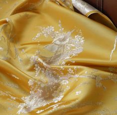 the fabric is yellow with white flowers on it