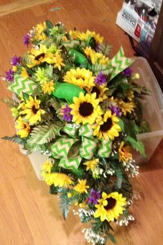 a bouquet of sunflowers and greenery on the floor