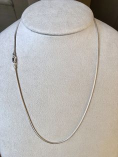 Featuring a smooth, fluid look and bright finish, this round sterling silver seamed snake chain necklace is a great option for pendants that benefit from a strong, slender chain. Seamed snake chain is created with soldered, machine-made curb-style chain that is compressed twice, producing the snake-like appearance and leaving behind a telltale seam visible along its length. This chain is plated with fine silver to ensure a bright white color and to help protect against tarnish. A lovely chain to Silver Snake Chain Jewelry, Silver Minimalist Herringbone Necklace With Box Chain, Minimalist Snake Chain Necklace With Sterling Silver Clasp, Classic Silver Herringbone Necklace With Adjustable Chain, White Gold Sterling Silver Snake Chain Necklace, Classic Silver Snake Chain Necklace With Adjustable Chain, Sterling Silver Snake Chain Jewelry, Silver Snake Chain Jewelry With Delicate Chain, Silver Snake Chain Necklace With Adjustable Chain