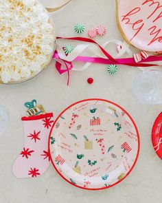 a table topped with plates covered in frosting next to christmas decorations and other items