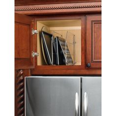 a kitchen cabinet with stainless steel appliances in it