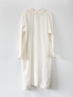 Relaxed off white linen dress with delicate light brown hand embroidery throughout. Hidden button closure at notch neck, buttoned cuffs, side seam pockets, and side slits at hem. Handmade in India. 100% Linen. Hand wash and lay flat to dry. Erica Tanov Elegant White Unlined Linen Dress, Unlined White Linen Dress, White Unlined Linen Dress, Elegant White Linen Dress With Buttons, White Unlined Linen Dress For Daywear, Elegant Embroidered Linen Dress, Elegant Tunic Linen Dress For Daywear, Elegant White Relaxed Fit Linen Dress, Elegant Linen Tunic Dress For Daywear