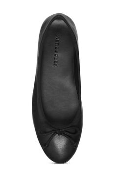 A dainty bow accents the toe of this contemporary ballet flat that pairs perfectly with any outfit! Slip-on Cushioned insole Round toe Vegan leather upper/synthetic sole Imported Elegant Black Ballet Flats For Everyday Wear, Elegant Black Ballet Flats For Everyday, Elegant Synthetic Ballet Flats With Rubber Sole, Classic Black Ballet Flats With Bow, Almond Toe Ballet Flats With Bow For Work, Black Ballet Flats With Bow And Flat Heel, Classic Black Flats With Bow, Casual Black Ballet Flats With Bow, Black Slip-on Ballet Flats With Bow