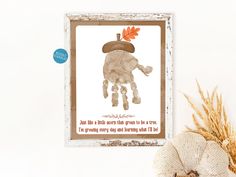 there is a picture frame with an image of a child's handprint on it