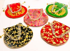 Potli Bag Dimension :- H*L (cm) : 23*24 ) , (H*L: 9* 9.5( Inch) (Handle Dimension :- H* L (cm) 20*14) (Type:-Pearl Drawstring) * Accessibility : Used to carry earrings, rings, bracelets and other jewelry items. Coins, cards with easy accessibility which keeps your items anti-dust. Other usage as storage for necklaces, bangles and other accessories to prevent it from tangling * This Potli Bag is Made From dupion silk , velvet, Product Primary Work at Brocade Patchwork, * Closure : Being lightweig Festive Multicolor Potli Bag For Party, Pink Party Bags For Diwali, Multicolor Potli Bag For Wedding And Navratri, Festive Multicolor Party Bags, Multicolor Handcrafted Bag For Diwali, Red Bags For Diwali Party, Multicolor Bags For Festivals, Multicolor Bollywood Potli Bag For Festivals, Festive Multicolor Bags With Dori Work