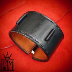 "This black leather cuff watchband uses the highest quality natural vegetable-tanned bridle leather and is hand stitched throughout. A soft calfskin lining hugs your wrist and a high quality roller buckle closes it up! I'll need your wrist size and watch size per the supplied pic. I Can size it for men or women Can be made many finishes and colors. Just ask! - 1-3/4\" wide - Hand saddle stitched - Vegetable tanned Bridle leather I can make most of my watchband styles to fit your Apple watch. Jus Luxury Leather Bracelets For Business, Business Leather Bracelets With Leather Strap, Business Bracelet With Leather Strap, Brown Leather Bracelet For Formal Occasions, Timeless Leather Bracelet For Formal Occasions, Black Leather Strap Cuff Bracelet, Modern Leather Strap Cuff Bracelet, Black Leather Cuff Bracelet For Formal Occasions, Modern Leather Cuff Bracelet For Formal Occasions