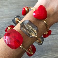 Red faceted heart acrylic beads on gold wire Can customize wire color (silver, gold, and rose gold) as well as size. Contact us if you prefer a size that is not offered. How to choose Size: Measure hand at its widest area (around knuckle and thumb area). This is the widest part that the bangle would go over when putting it on. This listing is for the red heart acrylic bead bangle only but you can find the other bangles in our shop at https://www.etsy.com/shop/Immeasurablymore2 Follow Immeasurabl Luxury Adjustable Red Bangle, Immeasurably More, Red Bangles, Wire Wrapped Bangles, Cream Earrings, Wrap Bangles, Bijoux Fil Aluminium, Bead Bangles, Jade Bracelet