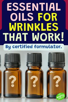 Pin with dark blue background. Large text reads "ESSENTIAL OILS FOR WRINKLES THAT WORK!" in pink and yellow. Subtitle says "By certified formulator." Below are three amber glass essential oil bottles with black caps, each labeled with a white question mark. An "Oh Mighty Health" logo appears in bottom right corner in green Reduce Neck Wrinkles